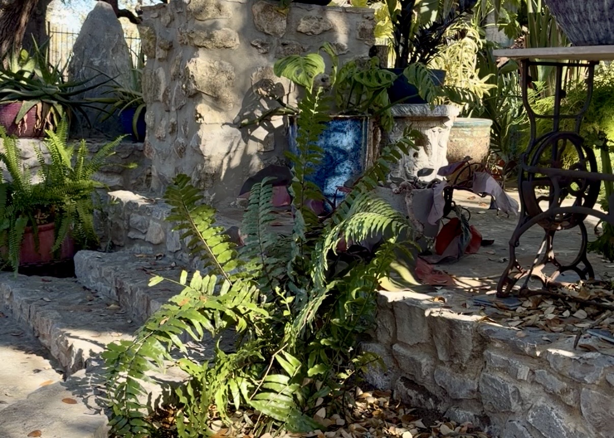In the built in waterfountain, there is a statue of a women.